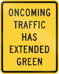 US road warning sign: Oncoming traffic has extended green