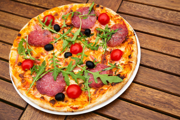 Delicious italian pizza served on wooden table