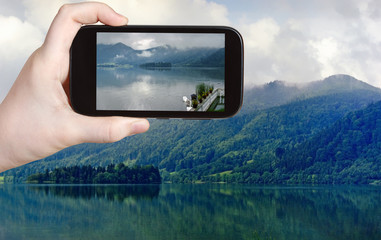 tourist taking photo of Schliersee lake, Bavaria