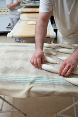 Obraz na płótnie Canvas Kneading and placing pieces of bread over fermentation table