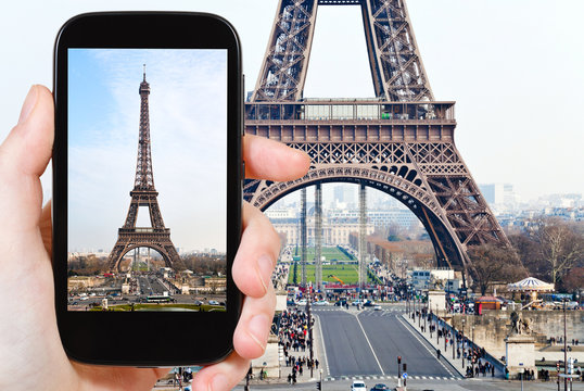 tourist taking photo of Eiffel tower in Paris
