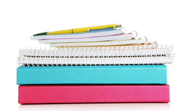 Colorful notebooks and pen, isolated on white