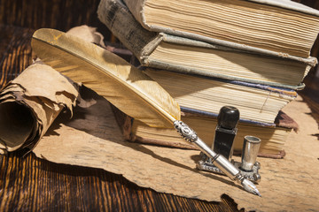 Vintage golden pen and ancient manuscripts
