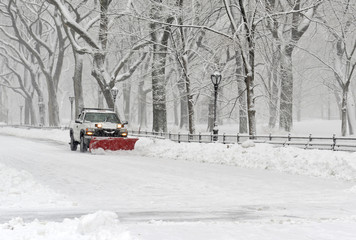 Truck with snowplow clearing road during snowstorm - 79397489