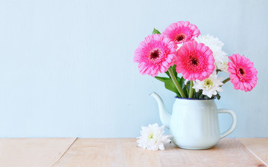 summer bouquet of flowers on the wooden table with mint backgrou