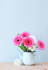 summer bouquet of flowers on the wooden table with mint backgrou