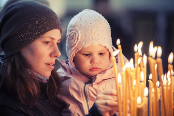 Mother and little blond Caucasian daughter in Church