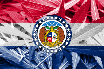 Missouri State Flag on cannabis background. Drug policy. 
