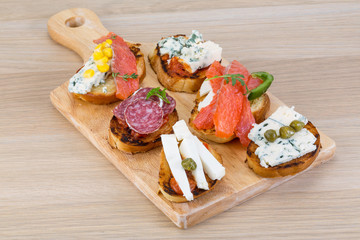 Tapas with cheese, salami and salmon