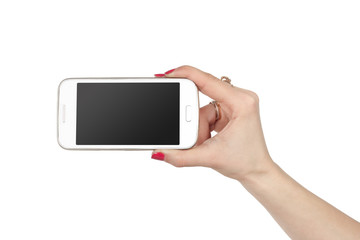 Woman showing white smartphone in hand. Isolated background