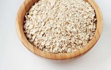 Wooden bowl of rolled oats