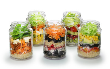 Fototapeta na wymiar vegetable salad in glass jar on white background, no lid
