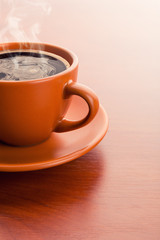 Cup of hot coffee on the table