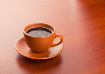 Cup of hot coffee on the table