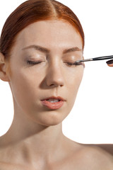 Fototapeta premium Pretty Woman Applying Eye Shadow Makeup