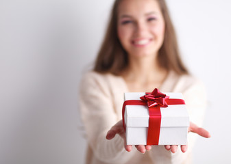 Young woman happy smile hold gift box in hands,standing over