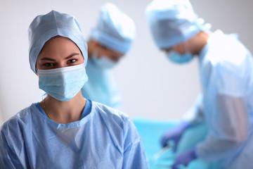 Team surgeon at work in operating room.
