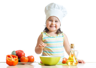 toddler girl preparing healthy food in the kitchen