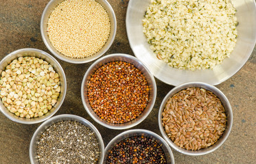 Collection of healthy grain in round metal containers