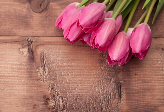 Tulips flowers on wooden table