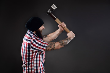 Furious lumberjack man swinging his axe