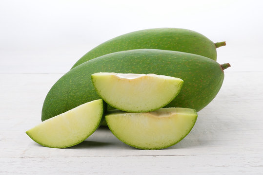 Fresh green mango on white wooden
