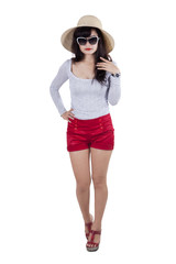 Fototapeta premium Fashionable woman with hat in studio