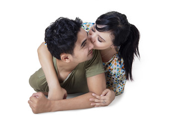 Woman kiss her husband on white background