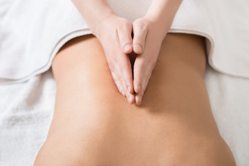 Obraz na płótnie Canvas Woman Receiving Back Massage in Spa Center