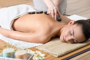 Obraz na płótnie Canvas Woman Receiving Back Massage in Spa Center