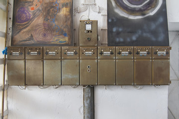 View of old row of electrical boxes on a wall. - obrazy, fototapety, plakaty