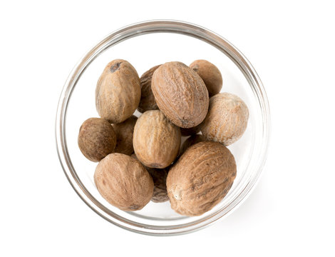 nutmeg in a bowl isolated on white