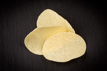Potato chips on a black background