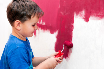 boy painting the wall red in the apartment