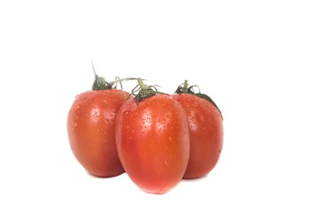 Three ripe juicy tomatoes with dew drops