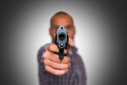 A Man Aims A Semi Automatic Pistol Focused On The Front 