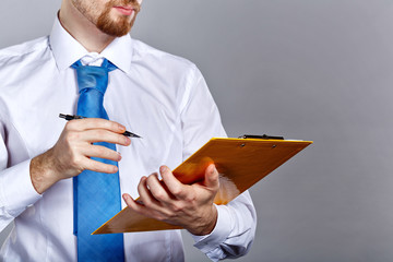 Businessman holding folder and pen