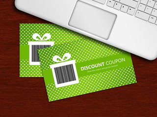 spring discount coupons with laptop lying on table