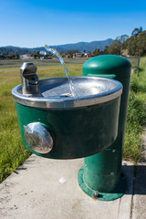Water stream squirts from a drinking fountain