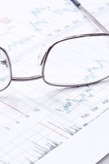 Eyeglasses lying down on a business document