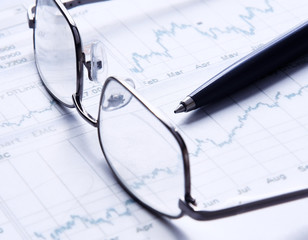 Eyeglasses lying down on a business document
