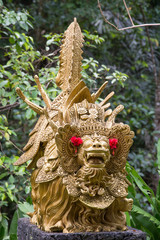 Traditional stone sculpture in garden . Bali, Ubud, Indonesia