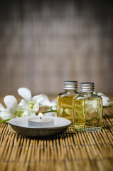 Macro of spa product, massage oil and orchid