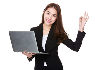 Businesswoman use of laptop and ok sign