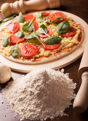 Raw Italian pizza with sausages