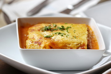 italian lasagna on a square plate