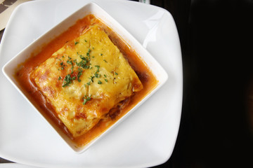 italian lasagna on a square plate - 79424214