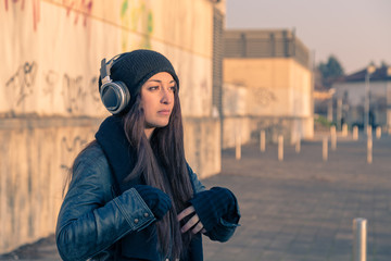 Beautiful young woman posing in the city streets