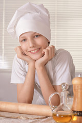 boy with dough prepares cookies