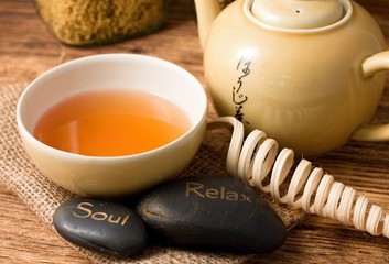 Tea set on wooden board and lava stones